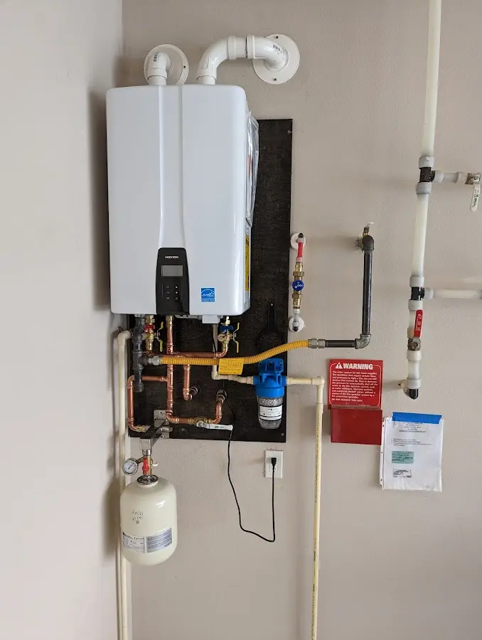 Professional plumber installing copper piping in a Kendall home